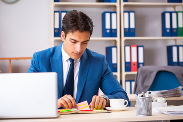 Young handsome businessman working in the office 