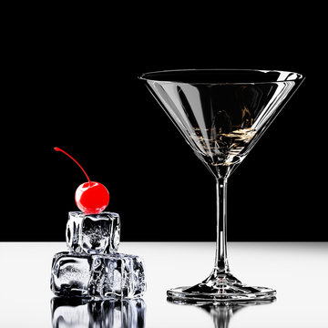 Cocktail glass with cherries and ice cubes. 3D render