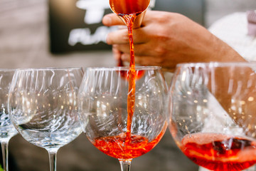 Red cocktail with strawberries. Strawberry daiquiri made with rum,brandy,lime juice, fresh strawberries,grenadine. Refreshing cocktails for a big company. A party. Soft focus.