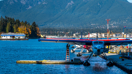 Fototapeta na wymiar Seaplanes floating at the dock, waiting for tourists. Vancouver, British Columbia, Canada.