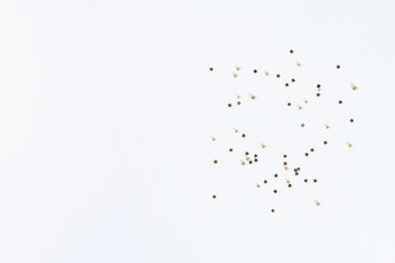 Obraz premium Christmas layout. Golden confetti in the form of stars on a white background. New Year 2019, christmas, winter concept. Copy space, tov view, flat lay composition.