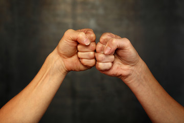 Two woman hands with fists in greeting gesture