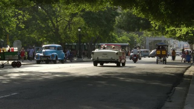 Busy everyday cuban life, old classic American 1950's vintage car taxi in Vieja neighborhood old Havana, Cuba