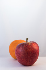 Orange fruit and red apple