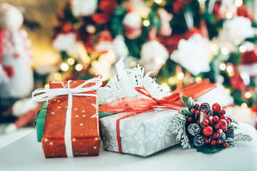 Christmas gifts, in the background a blurred Christmas tree