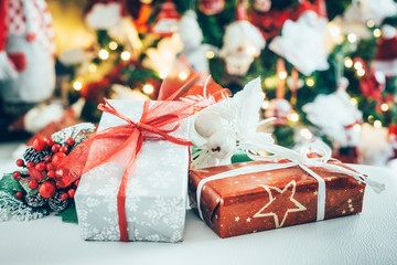Christmas gifts, in the background a blurred Christmas tree