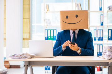 Happy man with box instead of his head
