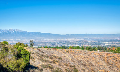 Fototapeta na wymiar Dry hilltop above suburbs of Southern California