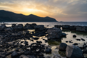 Stunning sunset on the rocky coast of Favignana, Aegadian Islands, Sicily, Italy