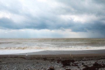 Sea coast during a storm, white foam and waves