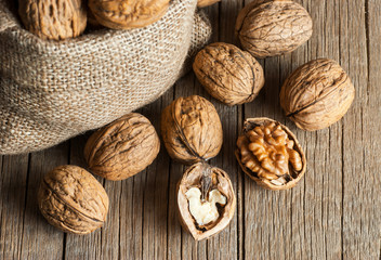 Pile whole big walnut kernel with thin shell on wooden vintage rustic backdrop. healthy food for brain. Fresh walnuts  background concept

