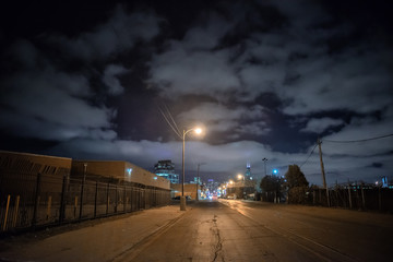 Industrial urban street city night scene with vintage factory warehouses and train tracks - obrazy, fototapety, plakaty