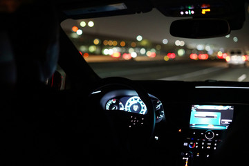 driving a car at night in the city - Powered by Adobe