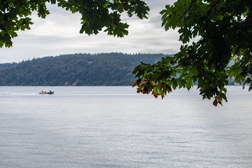 boat on calm water with overcast sky