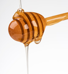 Stick with honey isolated on white background