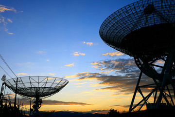 The silhouette of a radio telescope