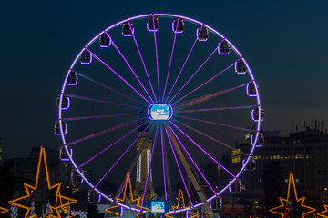 Lisbon, Portugal - Circa December 2018: Ferris wheel in Christmas fair at dusk