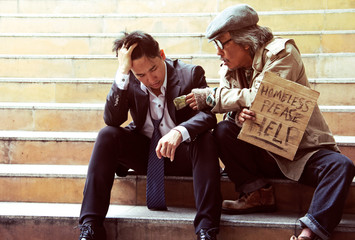 Business man and homeless man on walking street.