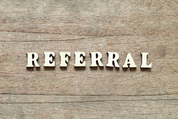 Letter block in word referral on wood background