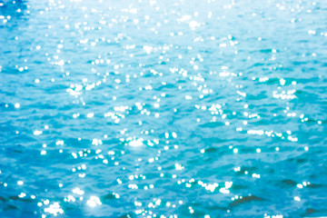 Abstract bokeh sunlight background with summer blue sea.