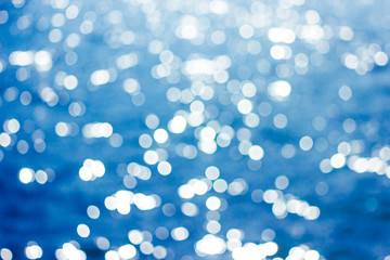 Abstract bokeh sunlight background with summer blue sea.