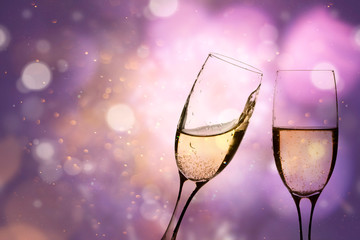 Glasses of champagne against holiday lights