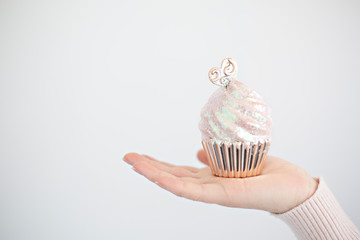 cupcake in hand isolated on white
