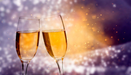 Glasses of champagne against holiday lights