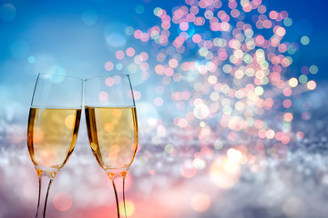 Glasses of champagne against holiday lights