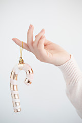 candy cane ornament in hand