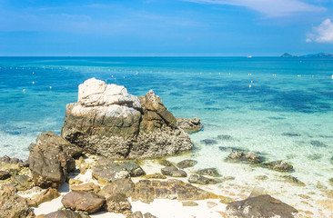 Tropical island rock on the beach with blue sky. Koh kham pattaya thailand.
