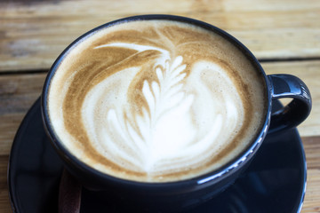 coffee cup with morning sunlight on wood table background