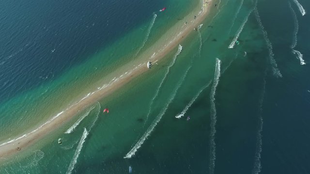 Aerial view faraway of group kitesurfing at Gulf of Patras, Greece.