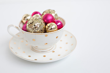 christmas balls in bowl on white background
