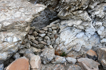 Tibet. Stoned entrance to small cave on the shore of Rakshas Tal lake
