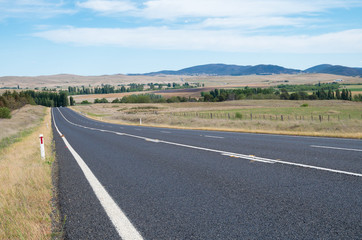 Australian rural road and landscape with a dead fox on the road