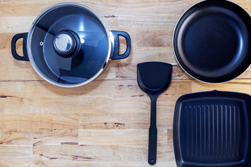 Top view frying pan and pot on wooden table
