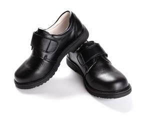 pair of brand new black leather shoe for children on white background