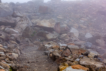harsh stone and graval pathway for hiking in fog and clouds