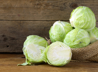 Ripe white cabbage on a wooden table