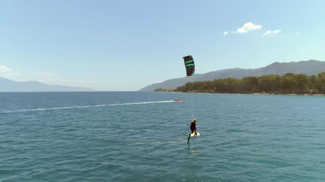 Aerial view of person kitesurfing in the Gulf of Patras, Greece.