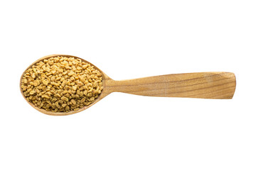 fenugreek seed in wooden spoon isolated on white background. spice for cooking food, top view.