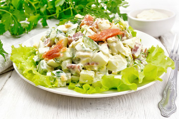 Salad of salmon and avocado with mayonnaise on light wooden board