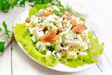 Salad of salmon and avocado with mayonnaise on white wooden board