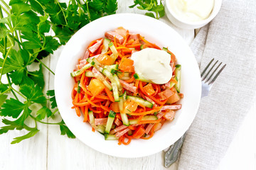 Salad of sausage and spicy carrots on board top