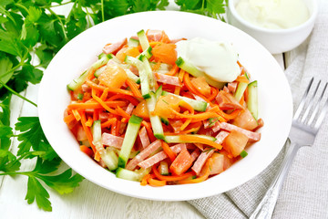 Salad of sausage and spicy carrots on board