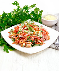 Salad of sausage and spicy carrots with mayonnaise on table