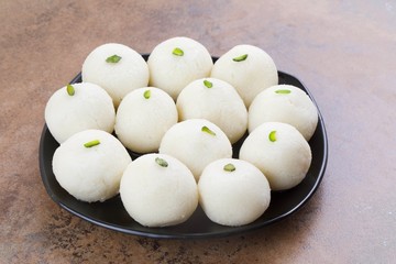 Indian Sweet Rasgulla Also Know as Rosogolla, Roshogolla, Rasagola, Ras Gulla, Anguri Rasgulla or Angoori Rasgulla is a Syrupy Dessert Popular in India. It is Made From Ball Shaped Dumplings