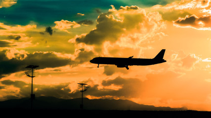 landing of the plane on the airfield against the bright sunny cloudy sky