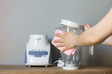 Close up woman hand cleaning juice blender.